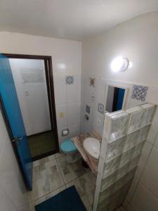a bathroom with a sink and a toilet and a mirror at Mar de Maria Pousada in Búzios +74 photos