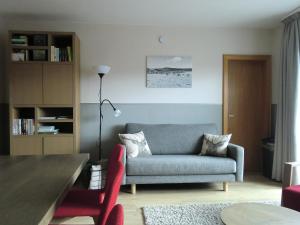 a living room with a couch and a table at Appartementen Edel in Schmallenberg
