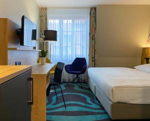 Ένα ή περισσότερα κρεβάτια σε δωμάτιο στο HKK Hotel Wernigerode