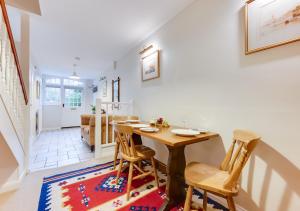 a dining room with a wooden table and chairs at Garden Flat in Sandwich