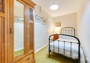a bedroom with a metal bed in a room at Garden Flat in Sandwich