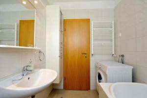 a bathroom with a sink and a washing machine at Lila1 Apartments in Zadar +30 photos