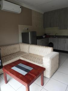 a living room with a couch and a coffee table at 2 Bed Apt with en-suite and kitchenette - 2066 in Harare