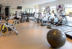 a gym with a lot of exercise bikes and exercise balls at Sands Resort Hotel in Newquay