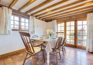 a dining room with a table and chairs at Iden Green Farm Stables in Benenden