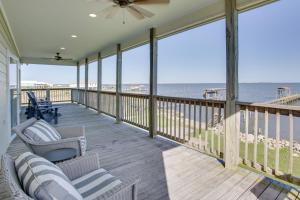 a screened porch with chairs and a view of the ocean at Lakefront NOLA Home with Hot Tub and Views! in New Orleans