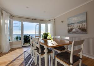 a dining room with a table and chairs at Melbury Abbas in Sandgate