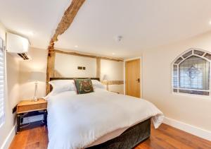 a bedroom with a large bed and a window at Longmace in Arundel