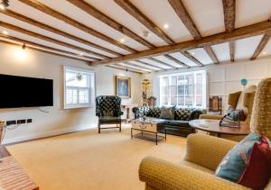 a living room with a couch and a tv at Longmace in Arundel