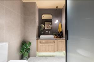 a bathroom with a sink and a mirror at Dash Living on Prat in Hong Kong