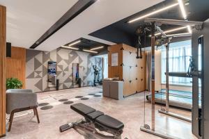 a gym with a treadmill and a chair in a room at Urcove by HYATT Shanghai Wujiaochang in Shanghai