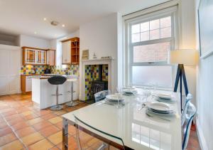 a white dining room with a white table and chairs at Number 46 in Whitstable