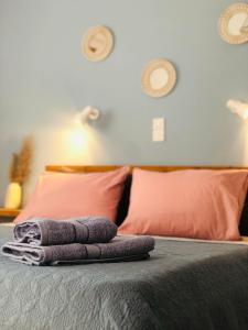 a pile of towels sitting on top of a bed at Niotis Studios in Kalymnos