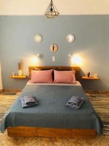 a bedroom with a large bed with two towels on it at Niotis Studios in Kalymnos