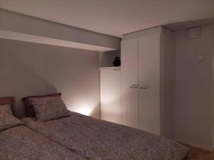 1 dormitorio con 1 cama y armario blanco en Keskusta uusi kalustettu kaksio., en Kuopio