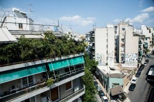 an apartment building with plants on the side of it at Let me take my bunk bed in Athens