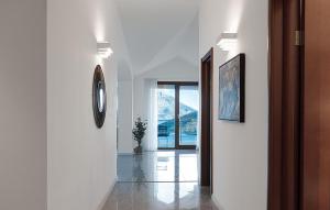 a hallway with white walls and a clock on the wall at Vidikovac Marble House in Budva