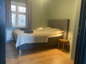 a bedroom with a bed in a room with a window at Randalín in Åkirkeby