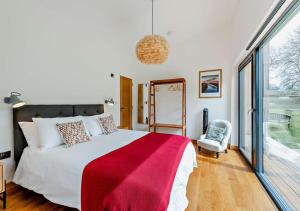 a bedroom with a large bed with a red blanket at River Birch in Beckley