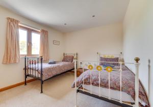 a bedroom with two beds and a window at Reynards in Beckley