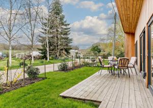 a wooden deck with a table and chairs on it at Silver Birch in Beckley