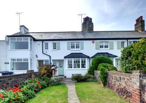 a white house with a garden in front of it at Napier Cottage in Broadstairs