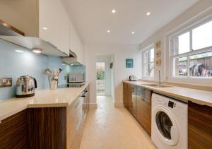 a kitchen with a washer and dryer in it at Napier Cottage in Broadstairs