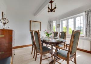 a dining room with a table and chairs at Rockmount in Saint Margaretʼs at Cliffe