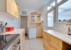 a kitchen with a sink and a dishwasher at Millers Cottage in Broadstairs