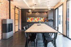 a large dining room with a table and chairs at L'ORIGINE in Saint-Aubin