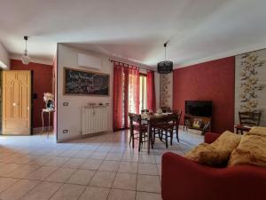sala de estar con paredes rojas, mesa y sillas en La Peonia, en Vitorchiano