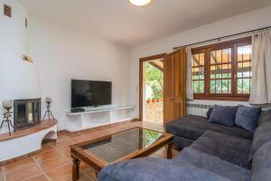 a living room with a couch and a tv at Tres Mares in Cala Bona
