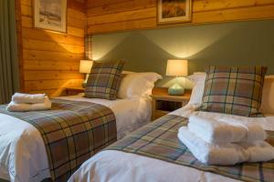 Stable Lodge tesisinde bir odada yatak veya yataklar