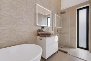 a bathroom with a white toilet and a mirror at Villa Enora in Las Palmas de Gran Canaria +22 photos