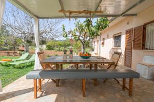 ein Holztisch und Stühle auf einer Terrasse in der Unterkunft Sa Caseta -Búger- in Búger