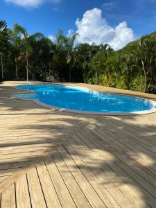 a blue swimming pool on a wooden deck at Villa Honu - Legends Residences - Stunning Ocean Views in Papetoai