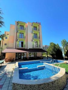 a hotel with a swimming pool in front of a building at Hotel 415 in Sunny Beach