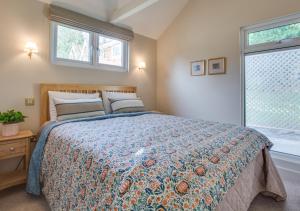 a bedroom with a large bed and a window at The Garden Cottage in Nutley