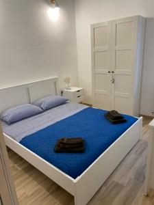 a bedroom with a large bed with blue sheets at Cà di Giaco lodge in Moneglia