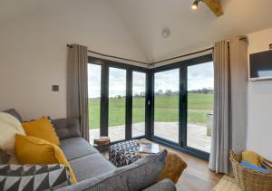 a living room with a couch and a large window at The Lookers Legacy in Stone