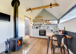 a kitchen and dining room with a wood stove at The Lookers Legacy in Stone