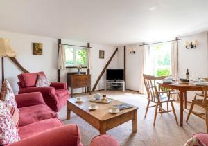 a living room with a couch and a table at The Bothy in Biddenden