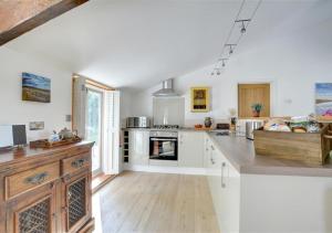 a kitchen with white cabinets and a counter top at The Hideaway in Eastry