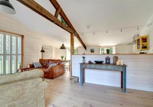 a living room with a table and a couch at The Hideaway in Eastry