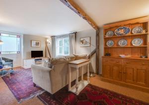 a living room with a couch and a table at The Little House in Rolvenden