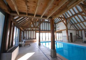 a swimming pool in a building with a wooden ceiling at The Old Pump House 