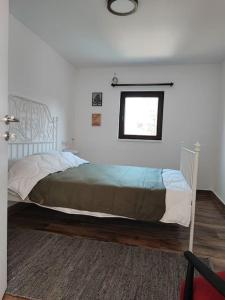 a bedroom with a large bed with a window at Linden Forest House 