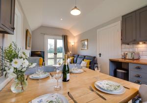 a dining room table with plates and wine glasses at The Warren in Biddenden