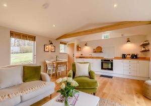 a living room with a couch and a table at Treetops at Bewl Water in Wadhurst