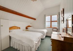 a bedroom with two beds and a window at Umballa in Herne Bay